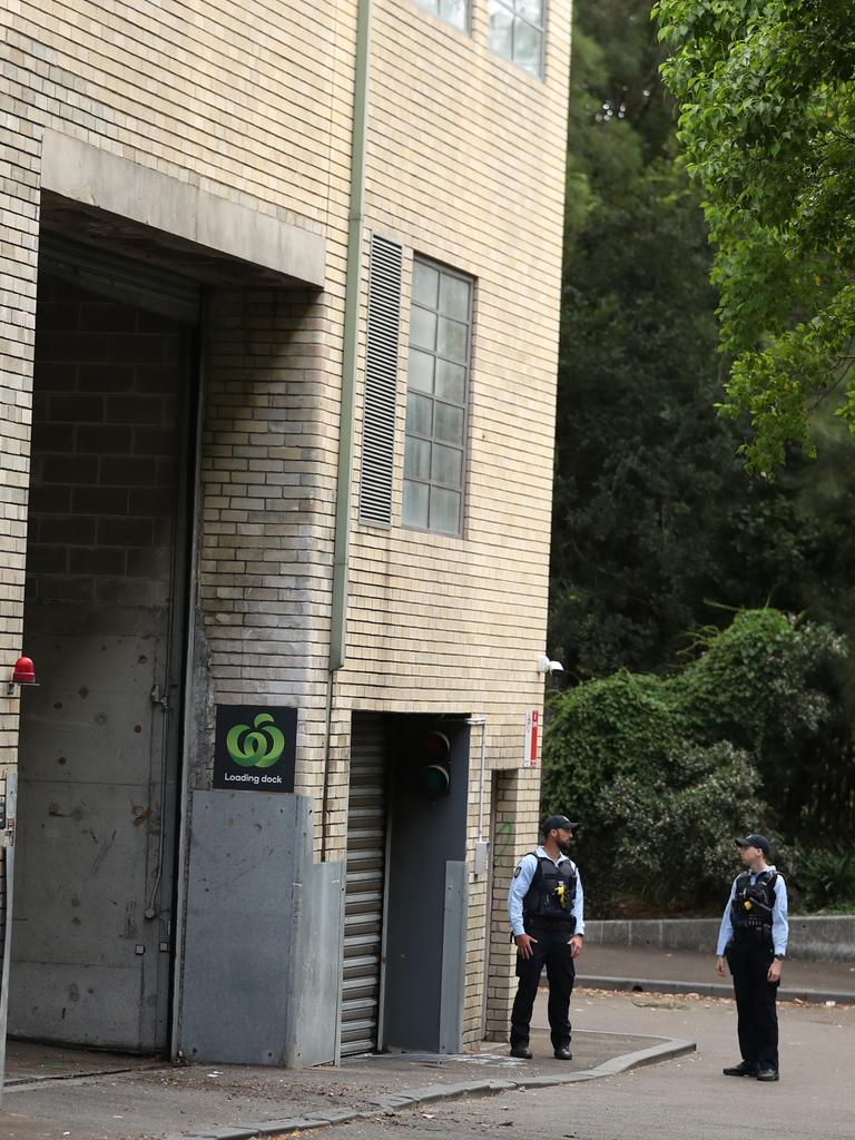 AFP officers guard the rear doors of the CFMEU in Pyrmont. Picture: John Grainger