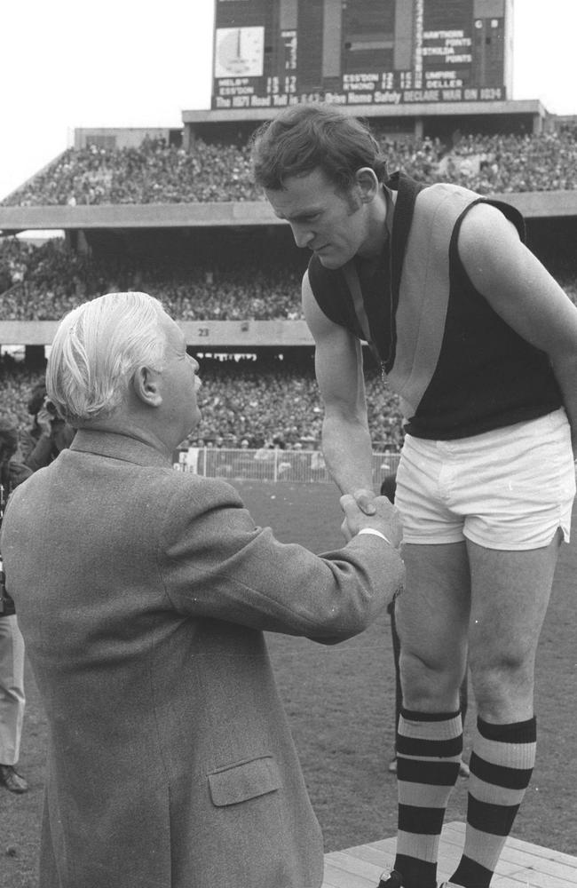 Ian Stewart receives the Brownlow Medal from the Governor, Sir Rohan Delacombe at the MCG in 1971.