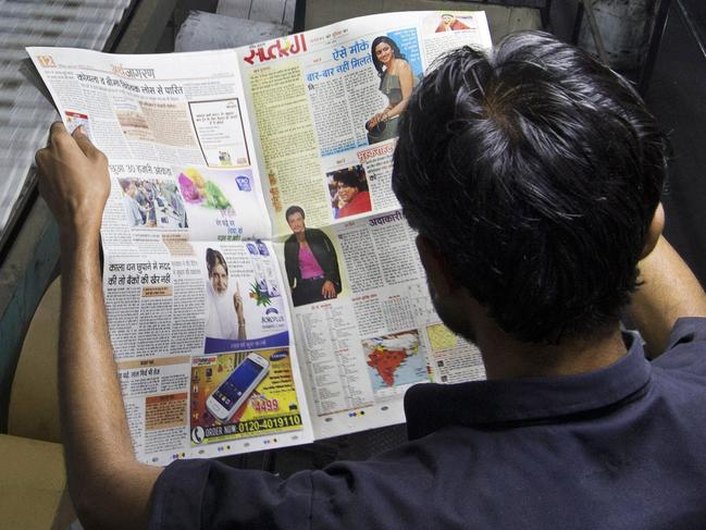 In this March 4, 2015 photo, a worker monitors the quality of print at the printing press of Dainik Jagran, one of India's largest vernacular dailies, in New Delhi, India. At a time when scores of American newspapers have downsized or shifted to online editions, the Indian newspaper industry is booming. Media analysts say the regional language newspapers are expected to clock double-digit figures in the coming decade as millions of new literates choose newspapers as their primary source of information. (AP Photo/Saurabh Das)