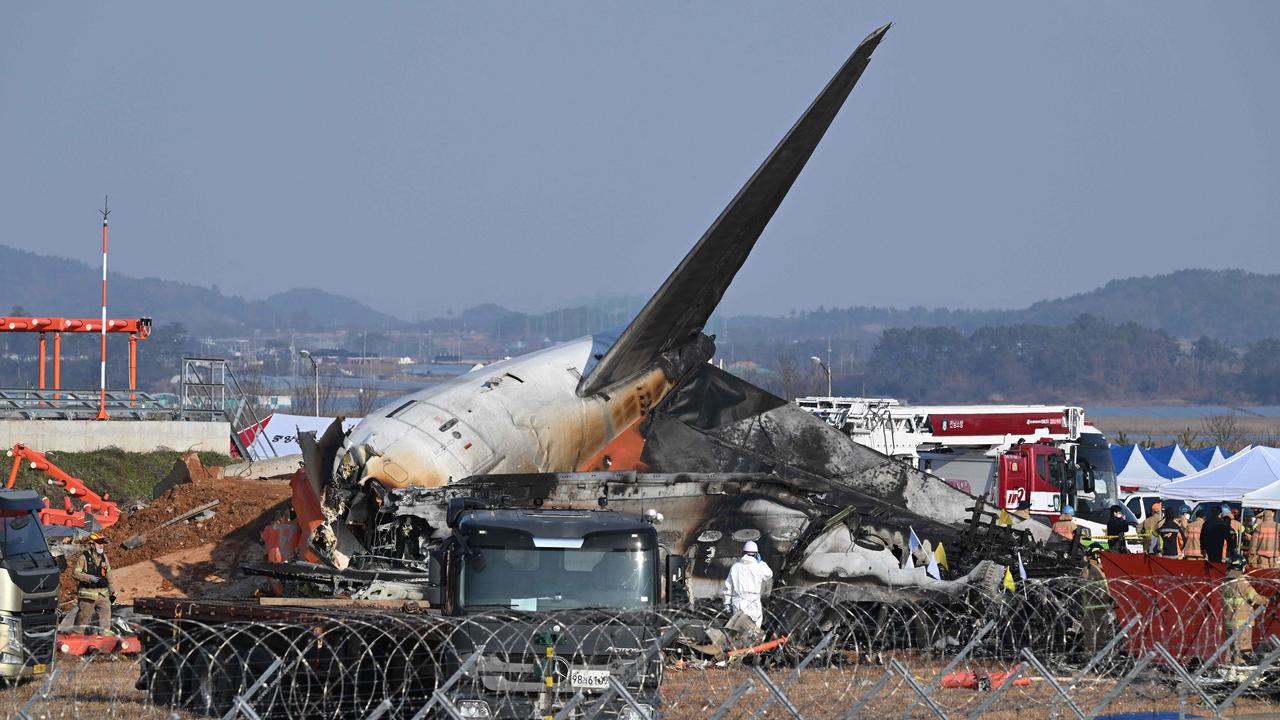 Firefighters and rescue personnel work near the wreckage of a Jeju Air Boeing 737-800 aircraft. Picture: Jung Yeon-Je / AFP