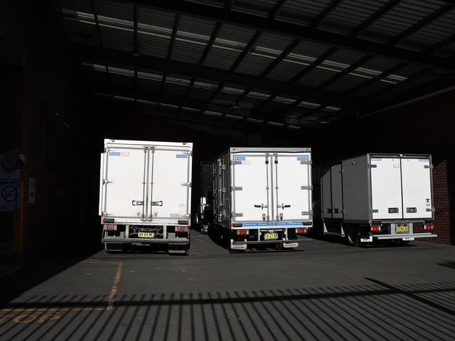 Trucks at Great Ocean Foods Marrickville locked behind gates. Picture: NCA NewsWire/Dylan Coker