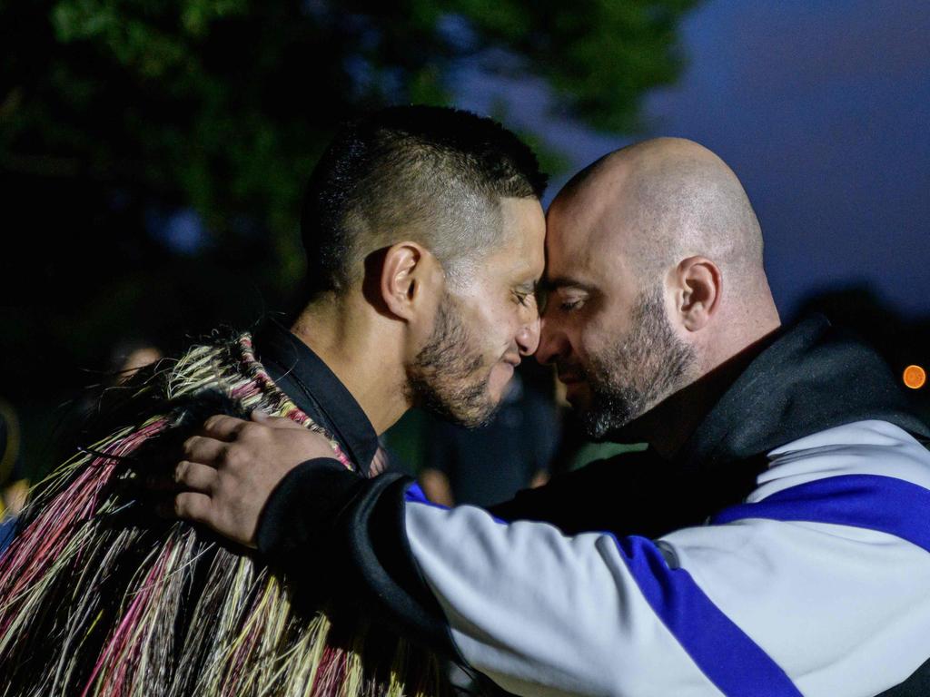 A Muslim man and another local perform a traditional Maori “hongi” greeting in front of the Al Noor mosque. Picture: AFP