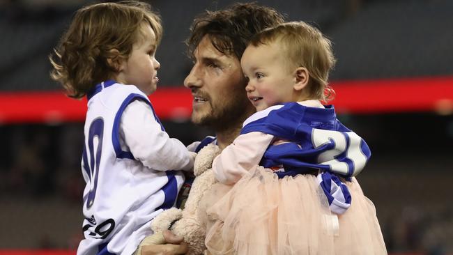 Jarrad Waite walks off for the final time with his children Teddy and Lola.