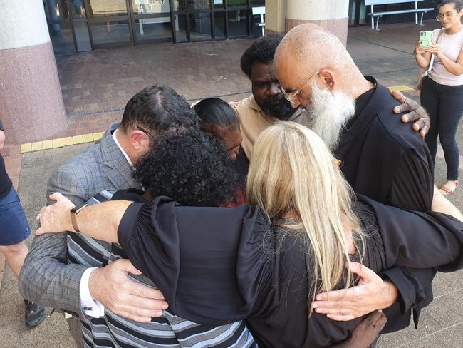 Ms Bernard's family and legal team hug at the conclusion of the second part of the coronial inquest into her 2013 disappearance, outside the Cairns courthouse. Tuesday, April 5, 2022.