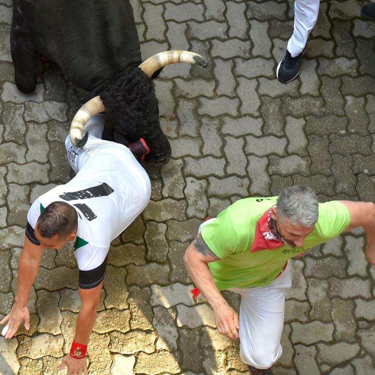 A runner goes down. Usually it ends up in cuts and bruises, but runners have been killed. Photo: Ander Gillenea