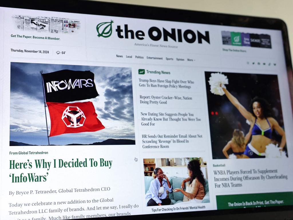 The Onion home page is displayed on a computer screen, showing a satirical story titled Here’s Why I Decided To Buy InfoWars in Pasadena, California. Picture: Getty Images via AFP