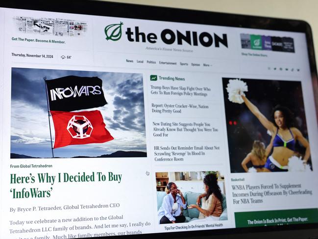 The Onion home page is displayed on a computer screen, showing a satirical story titled Here’s Why I Decided To Buy InfoWars in Pasadena, California. Picture: Getty Images via AFP