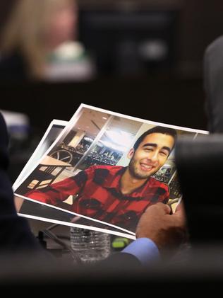 Pedro Bravo's defence attorneys look at a photo of slain student Christian Aguilar. Picture: Doug Finger