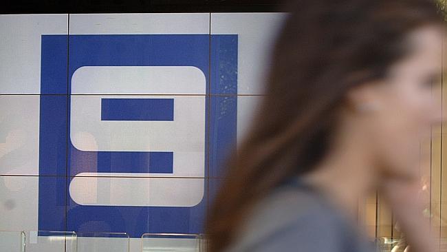 A pedestrian walks past the logo for Channel Nine television network in Sydney. Picture: Jack Atley.