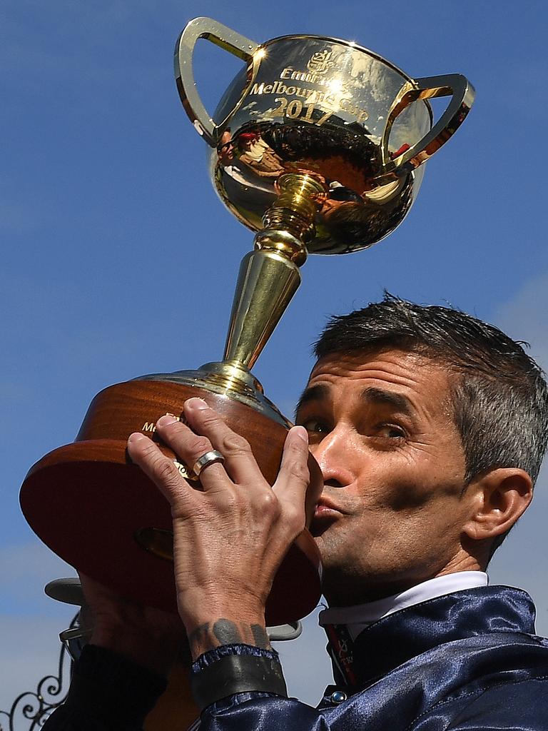 Jockey Corey Brown kisses the cup. Picture: Julian Smith/AAP