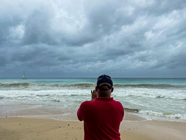 Tourists look at the sea waves as the hurricane Beryl passes near to Bridgetown, Barbados on July 1, 2024. Picture: AFP