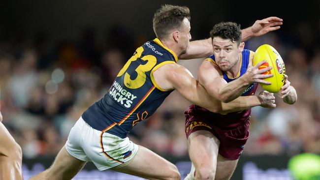 Lachie Neale under pressure from Brodie Smith. Picture: Russell Freeman/AFL Photos