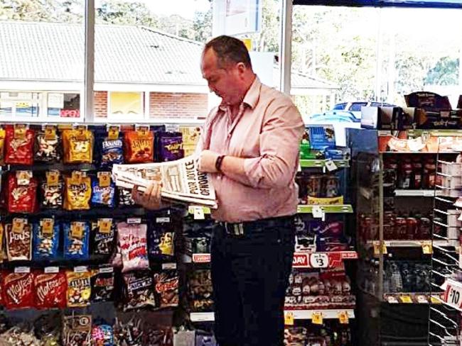 Barnaby Joyce reads the Daily Telegraph in a service station this morning. Supplied