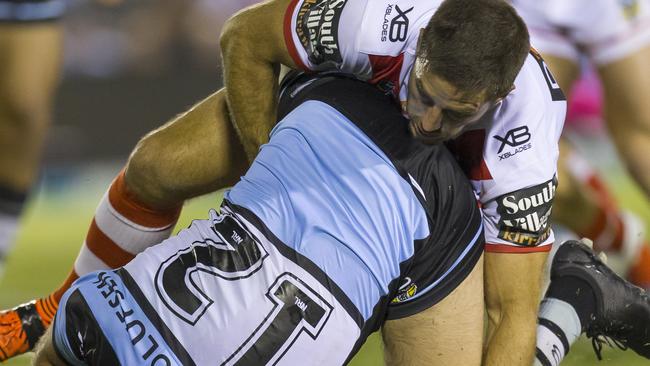 Wade Graham of the Sharks is tackled by Ben Hunt.