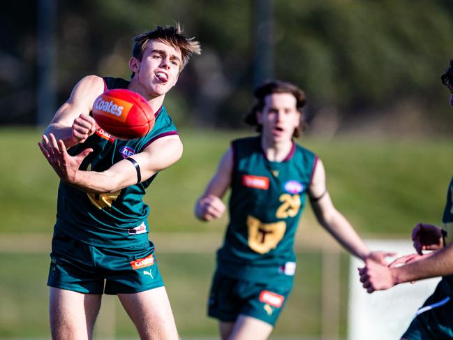 James Leake of Tasmania Devils gets the ball away. Picture: Linda Higginson