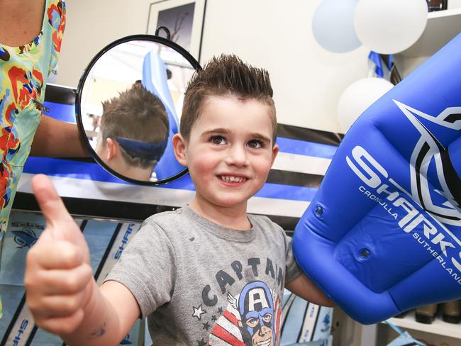 No tatts of course for Cronulla fan Bobby Magri, 4, but a Sharks logo cut into his hair by Karmila Kuts was the go / Picture: Dylan Robinson