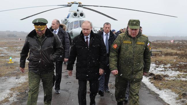 Putin (centre) and defence minister Sergei Shoigu (front left) walk to watch military exercises upon his arrival at the Kirillovsky firing ground in the Leningrad region, 2014. Picture: AFP