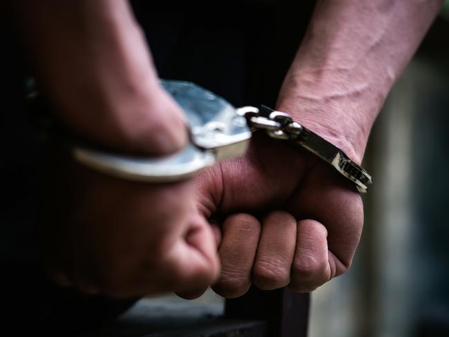 Man on the chair in Handcuffs. Rear view and Closeup ,Men criminal in handcuffs arrested for crimes. With hands in back,boy  prison shackle in the jail violence concept. Picture: Istock