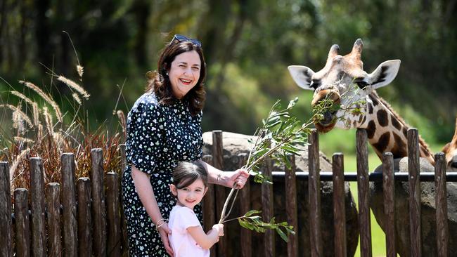 Annastacia Palaszczuk and her four-year-old niece Emma feed a giraffe during a visit to Australia Zoo on the Sunshine Coast during the 2020 election campaign. Picture: Dan Peled