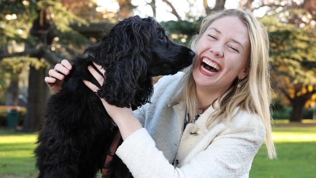 Amelia Hamer, the Liberal candidate for the seat of Kooyong, with ‘secret weapon’ Juno at Central Gardens, Hawthorn. Picture: Alex Coppel