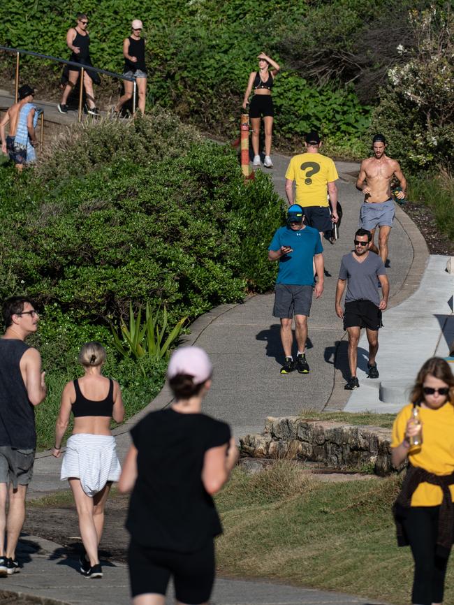 People walk and run near Mackenzies Bay, between Bondi Beach and Tamarama. Picture: AAP