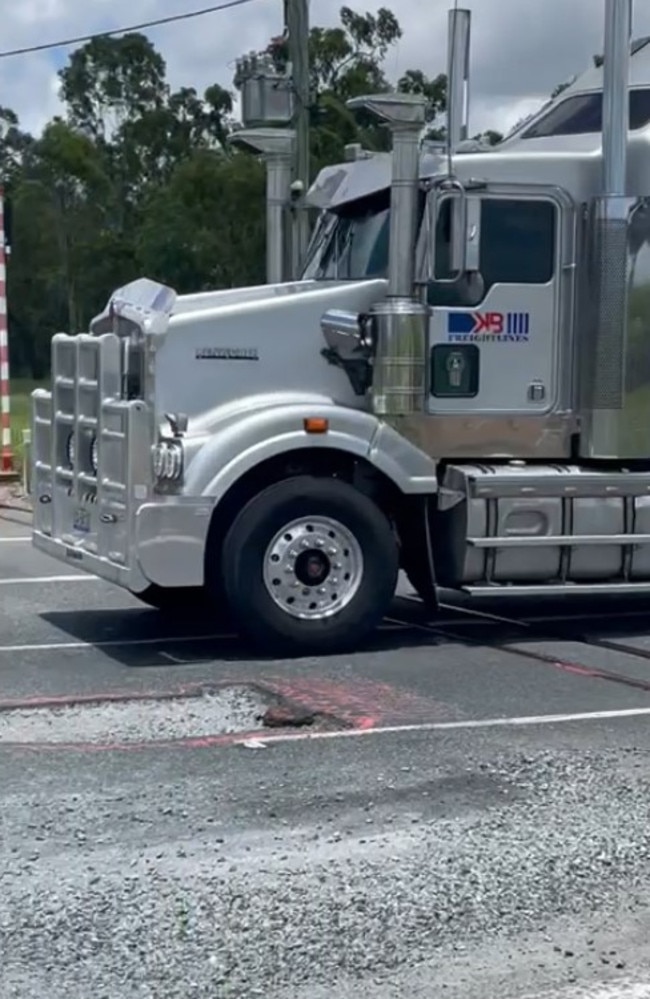 Motorists are having to swerve over solid white lines to avoid a massive pothole near Koumala south of Mackay along the Bruce Highway. Picture: Mitchell Dyer