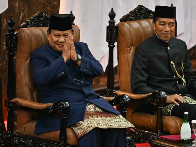 Indonesia's new President Prabowo Subianto (L) and his predecessor Joko Widodo (R) sit during the presidential inauguration at the Parliament building in Jakarta on October 20, 2024. Former general Prabowo Subianto was sworn in October 20 as president of Indonesia, seeking a more prominent position on the global stage for the world's fourth most populous nation. (Photo by BAY ISMOYO / AFP)