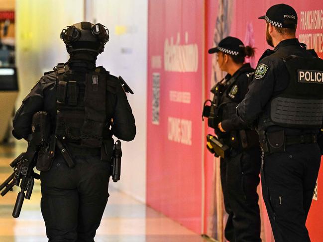 Heavily armed police and the Star Force stand guard at the entrance to the Westfield Marion shopping centre in suburban Adelaide on June 23, 2024, after the mall went into lockdown following a security incident where police say two groups of youths were fighting among themselves. (Photo by MICHAEL ERREY / AFP) / -- IMAGE RESTRICTED TO EDITORIAL USE - STRICTLY NO COMMERCIAL USE --