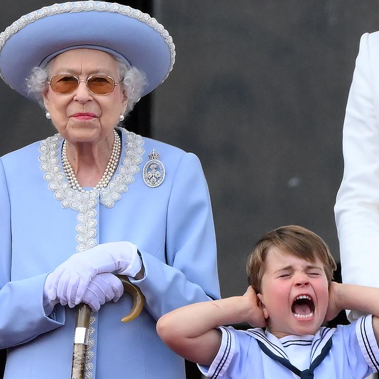 Four-year-old Prince Louis holds his ears and screams as his great-grandmother Queen Elizabeth II watches a special flyover by the air force as part of Platinum Jubilee celebrations. Picture: AFP