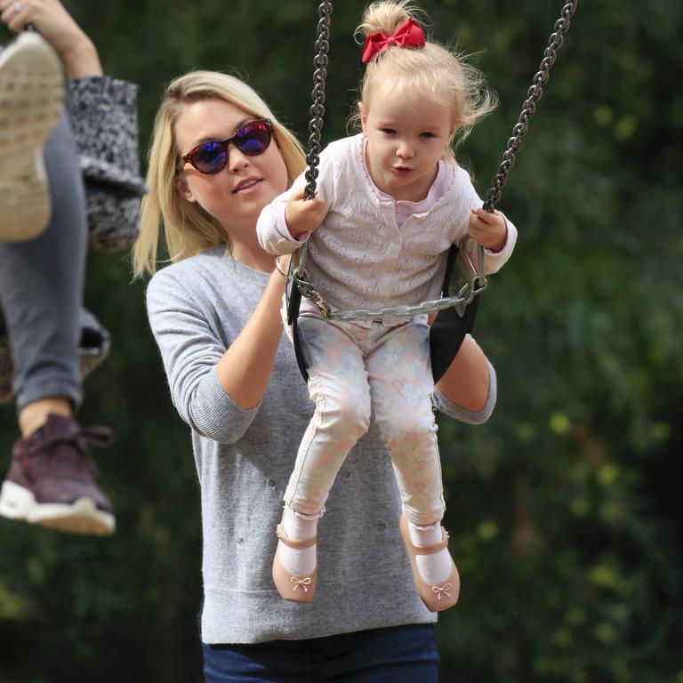 Jaimi pushing her half-sister Trixie on a swing in April 2016 at her third birthday party. Picture: Media Mode