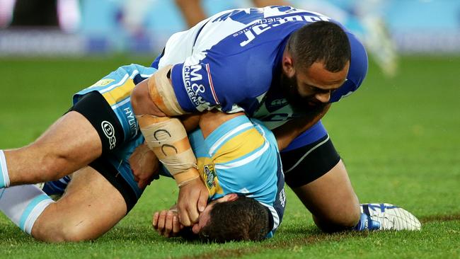 Aidan Sezer is crunched by Sam Kasiano.