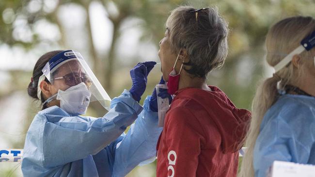 A woman takes a Covid test at the testing facility on the Esplanade. Picture: Brian Cassey