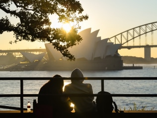 A couple sit at Mrs Macquarie's Chair at sunset during Sydney's COVID-19 lockdown. Picture: Getty Images