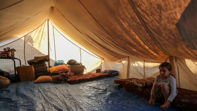 Children sit in a tent at a refugee camp set up for Palestinians seeking refuge along the Gaza Strip. Picture: Getty Images