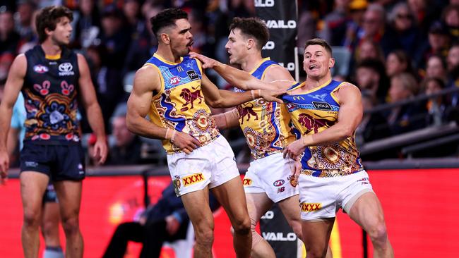 Charlie Cameron and Dayne Zorko celebrate a goal against Adelaide. Picture: James Elsby/AFL Photos via Getty Images