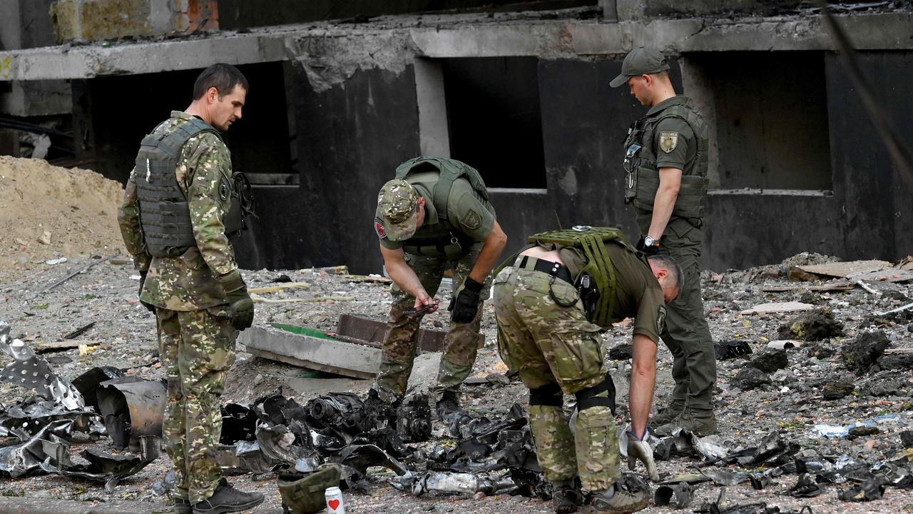 Ukrainian experts work outside a damaged residential building hit by Russian missiles in Kyiv. Picture: Sergei Supinsky