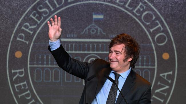 Javier Milei waves to supporters after winning the presidential election runoff at his party headquarters in Buenos Aires.