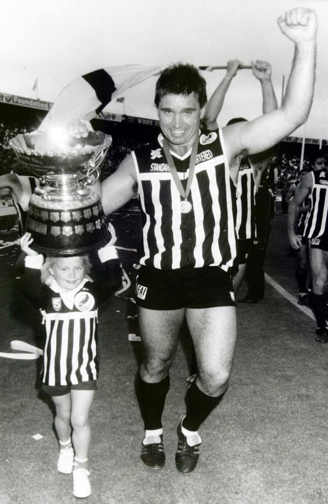 A young Erin helps her Port Adelaide legend Greg Phillips, after the Magpies’ 1990 SANFL grand final win.