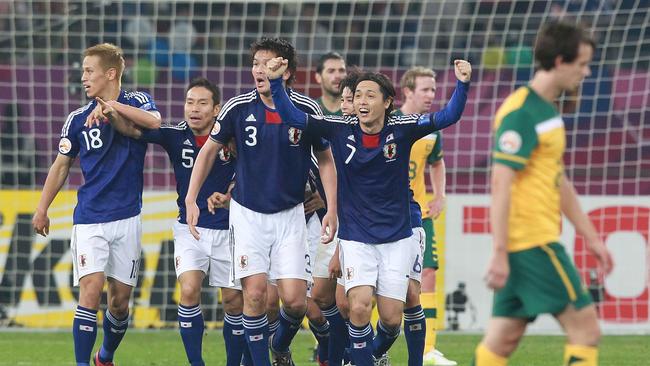 Robbie Kruse looks disconsolate as Tadanari Lee celebrates Asian Cup Final winner.