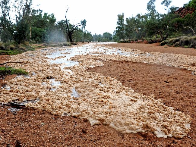 The first waters flow down the Todd River in Alice Springs on Thursday afternoon. Picture: Phil Williams