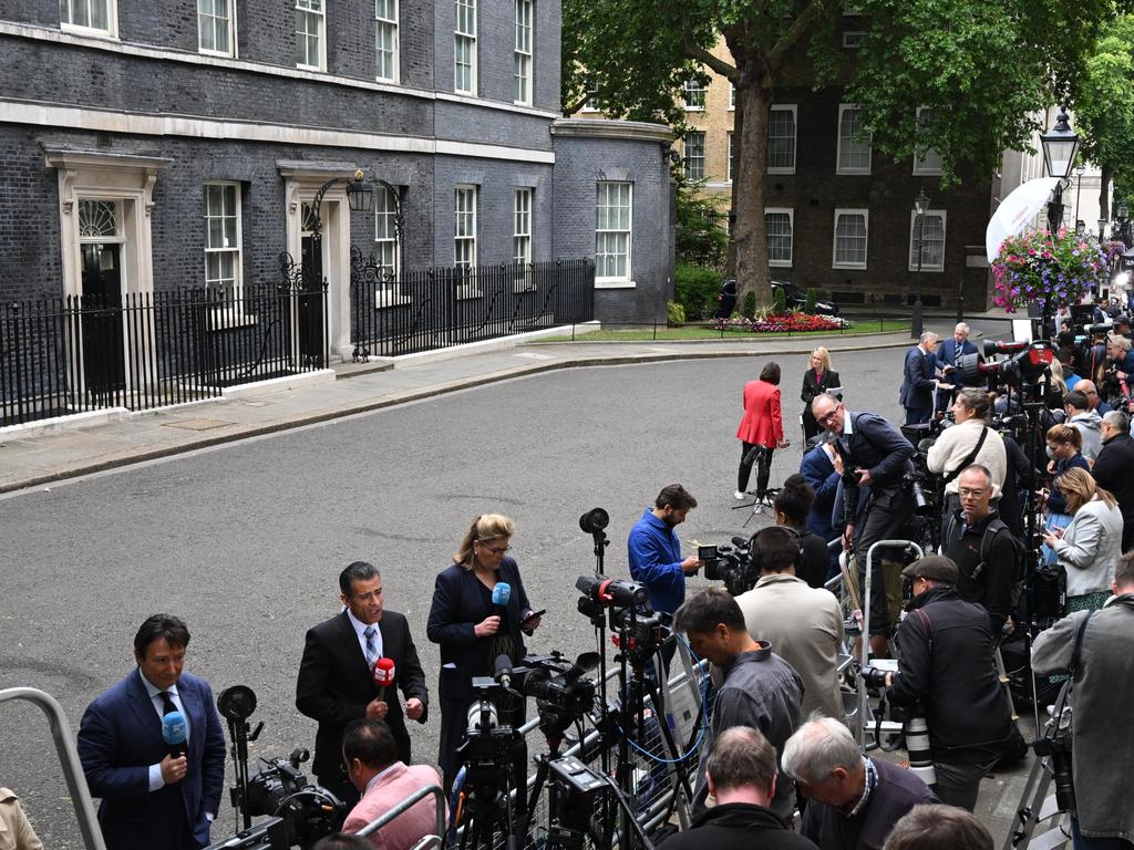 Members of the media gather outside 10 Downing Street.
