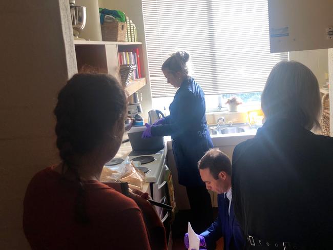 AFP officers going through News Corp journalist Annika Smethurst's kitchen. Picture supplied