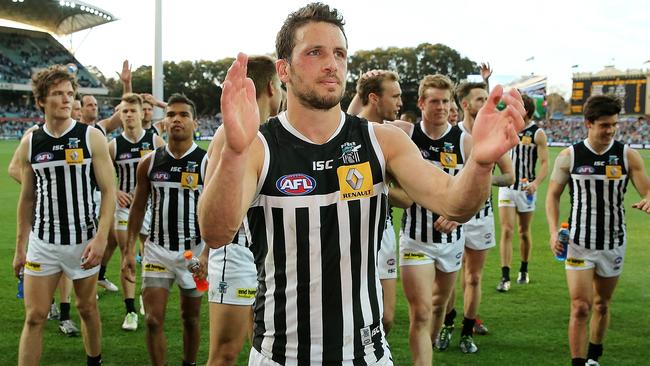 Travis Boak leads his Power teammates off Adelaide Oval.