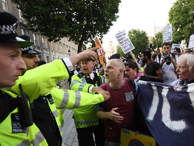 A scuffle breaks out as protesters attend a rally calling for justice for those affected by the Grenfell Tower fire outside Downing Street. Picture: Getty