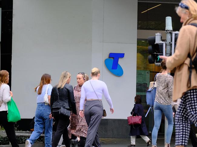 MELBOURNE, AUSTRALIA - NewsWire Photos OCTOBER 4, 2022. Generic photo people walking past the Telstra logo in Melbourne..Picture: NCA NewsWire / Luis Enrique Ascui