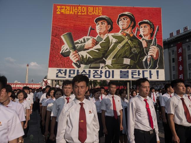 A propaganda poster is displayed during a rally in support of North Korea's stance against the US, on Kim Il-Sung square in Pyongyang on August 9. Picture: AFP