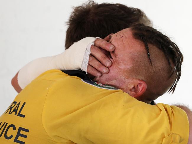 Troy Pauling with RFS firefighter Nathan Barnden who rescued his family from his parents burning home in Quaama, as they reunite in his Narooma motel. Picture: Jonathan Ng