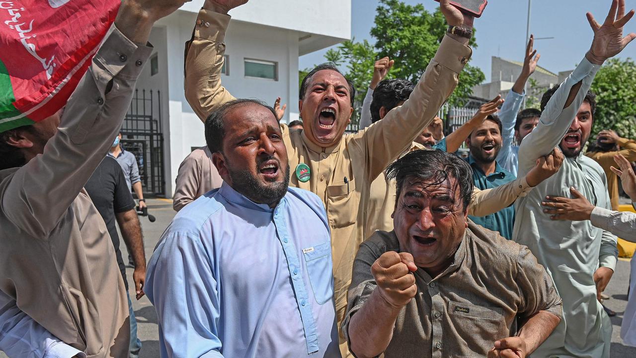 Supporters of PM Imran Khan shout slogans outside the Parliament House building in Islamabad on April 3. Picture:by Aamir Qureshi/AFP