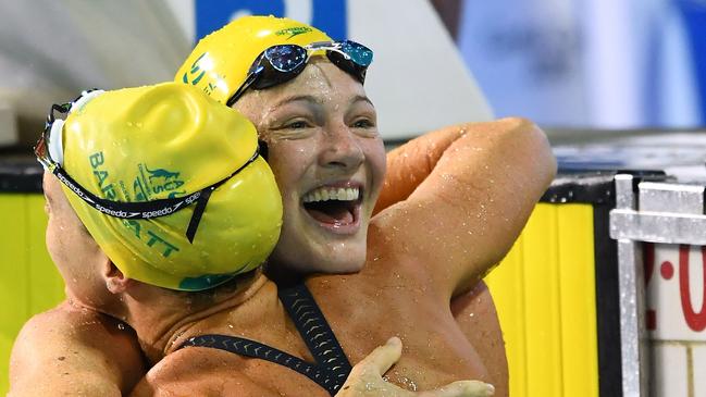 GOLD COAST, AUSTRALIA — APRIL 08: Cate Campbell of Australia (R) embraces teammate Holly Barratt as she celebrates victory in the Women's 50m Butterfly Final on day four of the Gold Coast 2018 Commonwealth Games at Optus Aquatic Centre on April 8, 2018 on the Gold Coast, Australia. (Photo by Quinn Rooney/Getty Images)