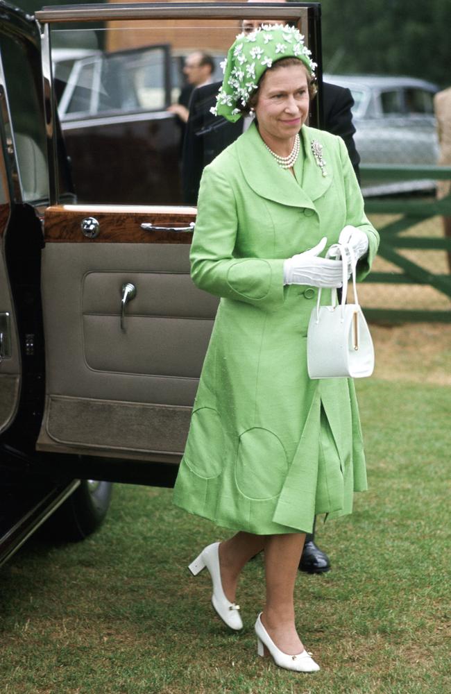 The Queen arrives at the polo wearing a silk mint green coat and matching dress with a green and white hat designed by milliner Simone Mirman. Picture: Tim Graham